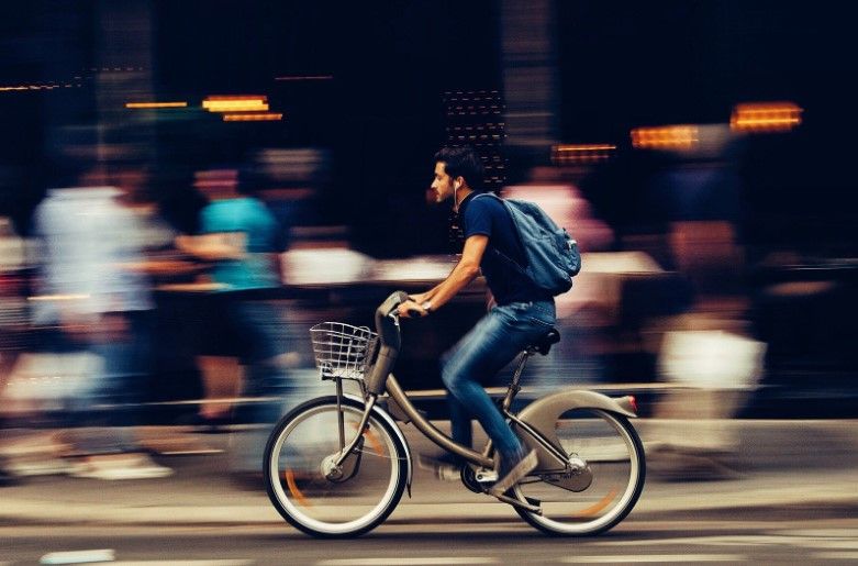 man riding a bicycle down a street